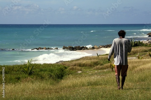 Black man walking on beach