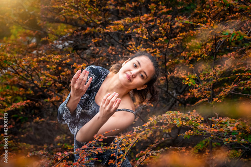 CLASSIC ARTISTIC DANCER IN THE FOREST ON AUTUMN. BEAUTY GIRL IN AUTUMN