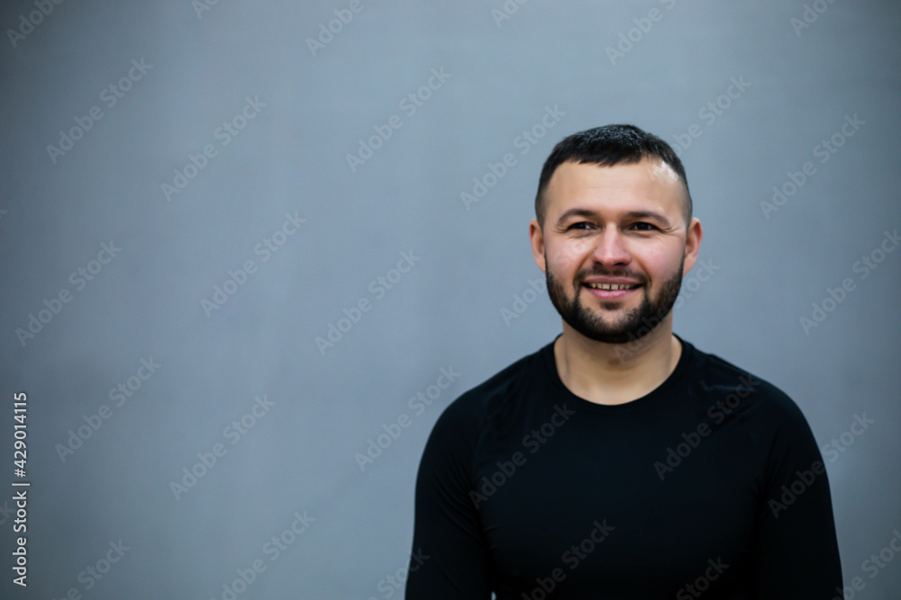 Confident bearded man with crossed hands isolated on gray background.