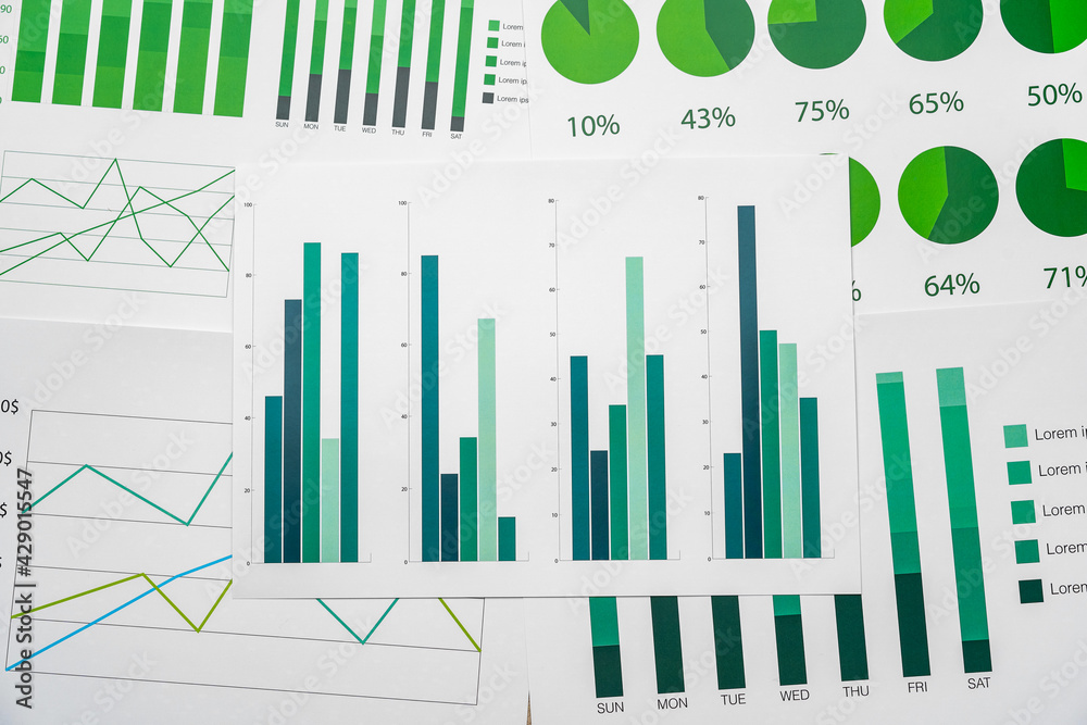 Financial paper with charts and diagrams on gray table Financial paper with charts and diagrams on gray table