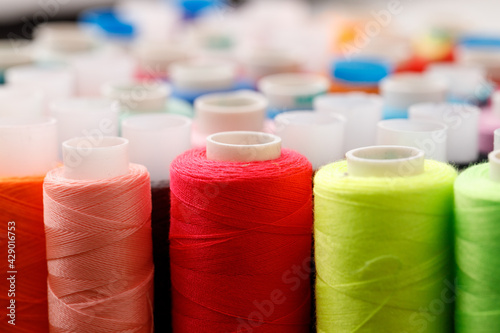 Close up of colored thread coils, thread spools background