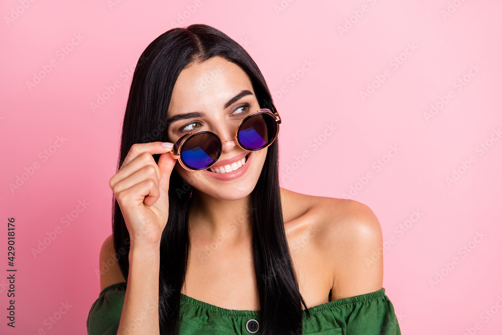 Photo of young cheerful girl happy positive smile wear sunglass dream look empty space isolated over pastel color background Photo of young cheerful girl happy positive smile wear sunglass dream look empty space isolated over pastel color background