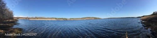 Panoramic shot of a quiet reservoir on a peaceful, sunny spring day