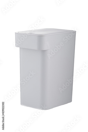 Subject shot of compact wastebasket with hidden handle and touch top bin. Gray versatile trash can is closed and isolated on the white background. © RedUmbrella&Donkey