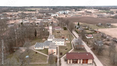 Drone flight over small rural vilage Umurga during spring time, Latvia