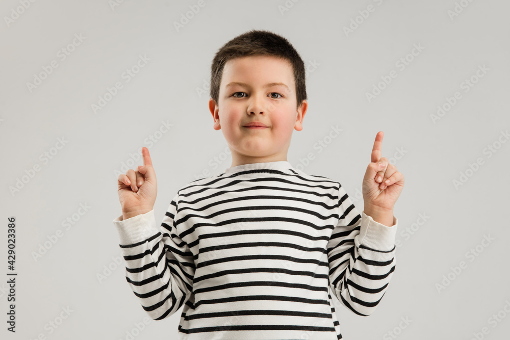 Caucasian boy isolated on white studio background. Copyspace. Childhood, education, emotions concept Caucasian boy isolated on white studio background. Copyspace. Childhood, education, emotions concept
