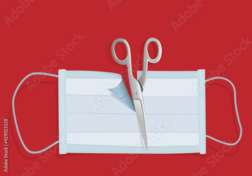 Concept de la vaccination, et de la victoire contre l’épidémie de COVID-19 avec un masque coupé en deux par des ciseaux pour symboliser le bout du tunnel.