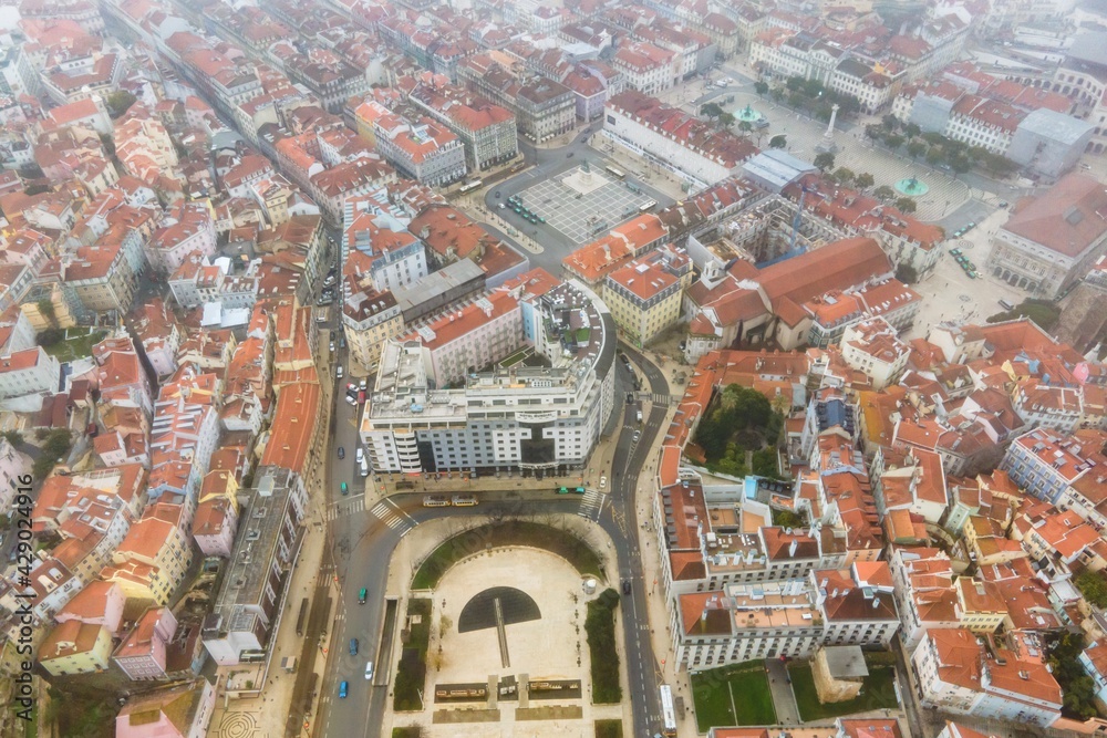 Aerial view of Rossio square in Lisbon downtown during a foggy and overcast day, Portugal.