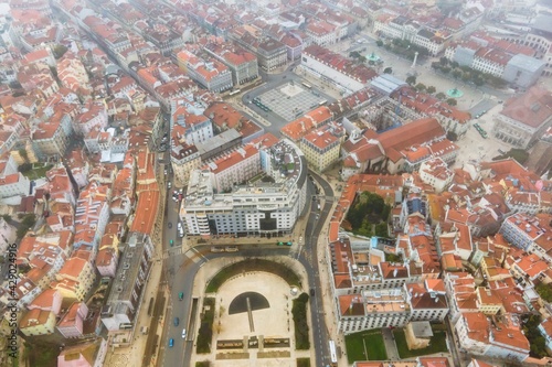 Aerial view of Rossio square in Lisbon downtown during a foggy and overcast day, Portugal. © Martina