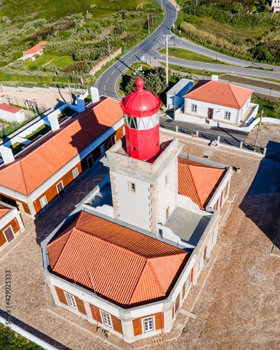 Aerial view of Cabo da Roca lighthouse, a natural coastline with a viewpoint over the cliffs facing the Atlantic Ocean, Colares, Lisbon, Portugal. photo