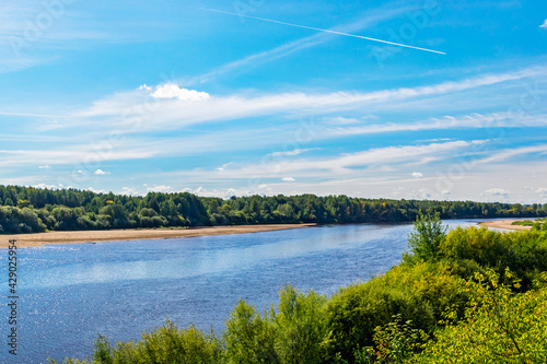 summer landscape with river and blue sky with clouds