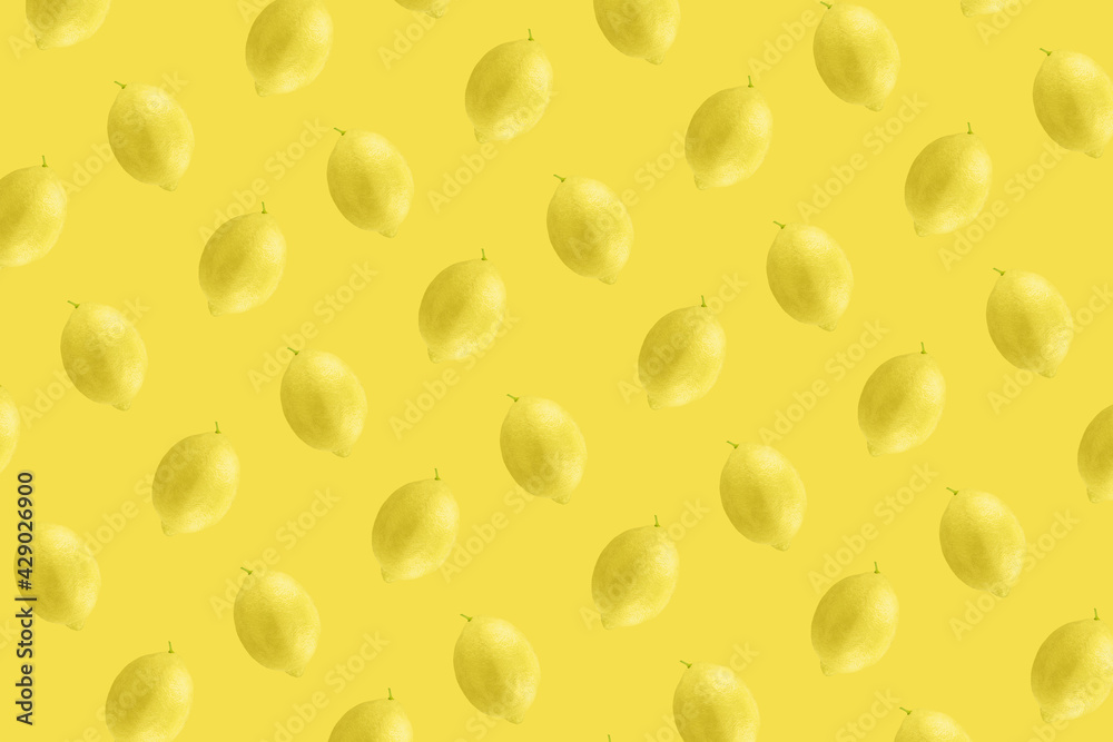 Whole lemon fruit pattern on yellow color background Whole lemon fruit pattern on yellow color background