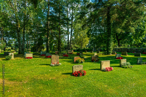 Rows of gravestones with colorful flowers