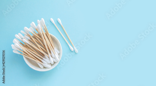 Bamboo cotton swabs or sticks top view on blue background
