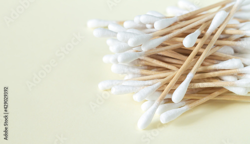 Bamboo cotton swabs or buds top view on beige background photo