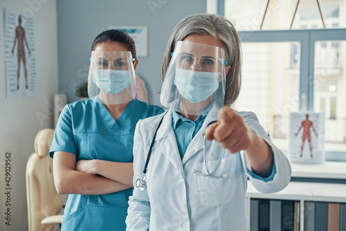 Two confident women coworkers in medical uniform 