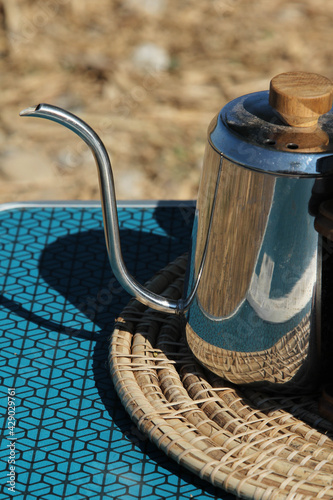 A hand drip coffee kettle on the table.