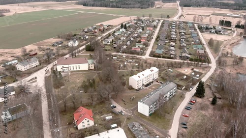 Drone flight over small rural vilage Umurga during spring time, Latvia