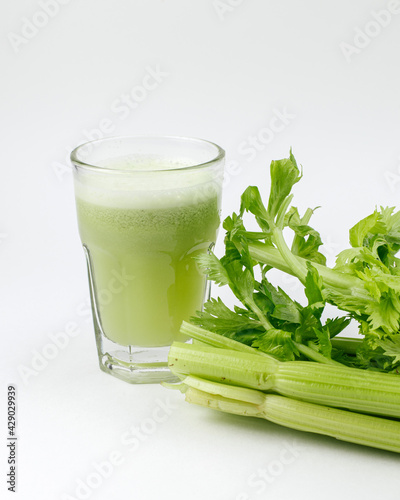 glass of fresh celery on a white background