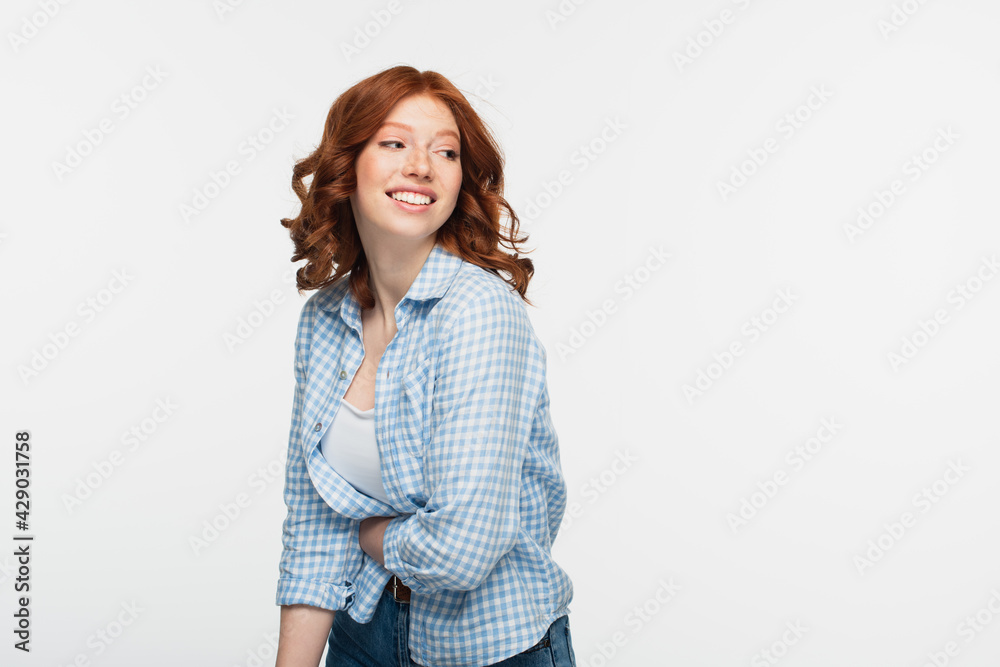 positive young woman in checkered shirt isolated on white. positive young woman in checkered shirt isolated on white.