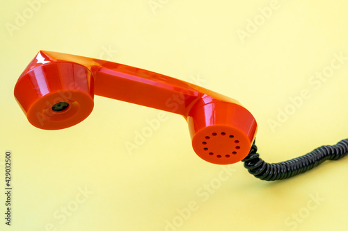 Retro orange telephone receiver, communication concept