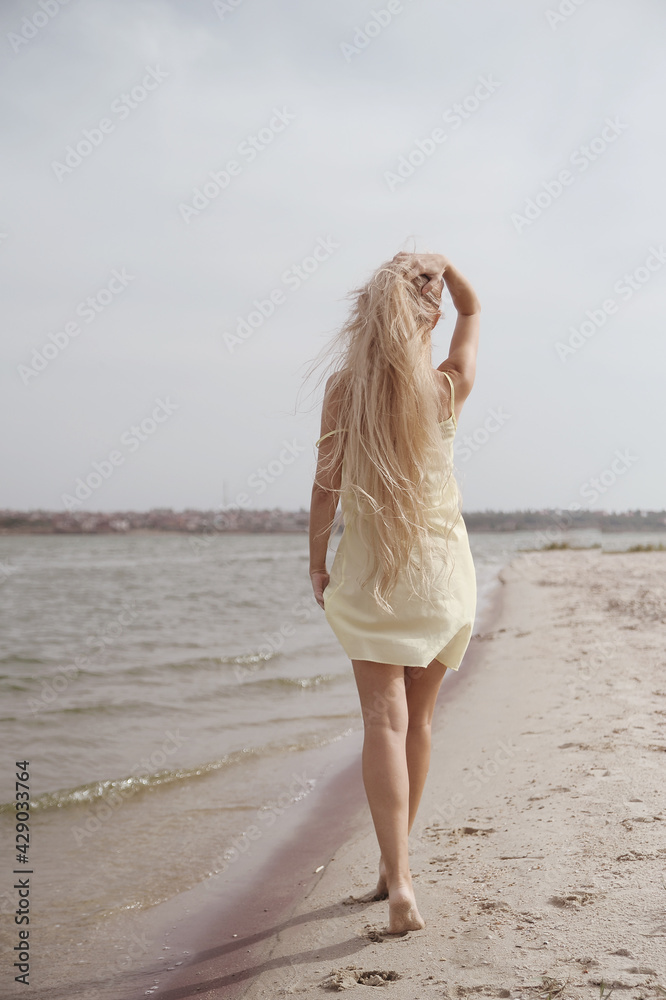 Beautiful blonde woman posing on the beach Beautiful blonde woman posing on the beach