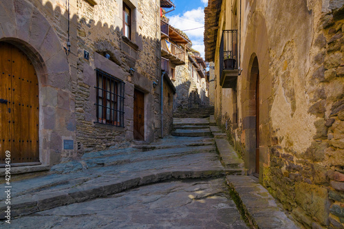 View of Fossar street, one of the most typical streets of the medieval center of Rupit where all the houses have the aesthetics of the medieval centuries. Catalonia, Spain