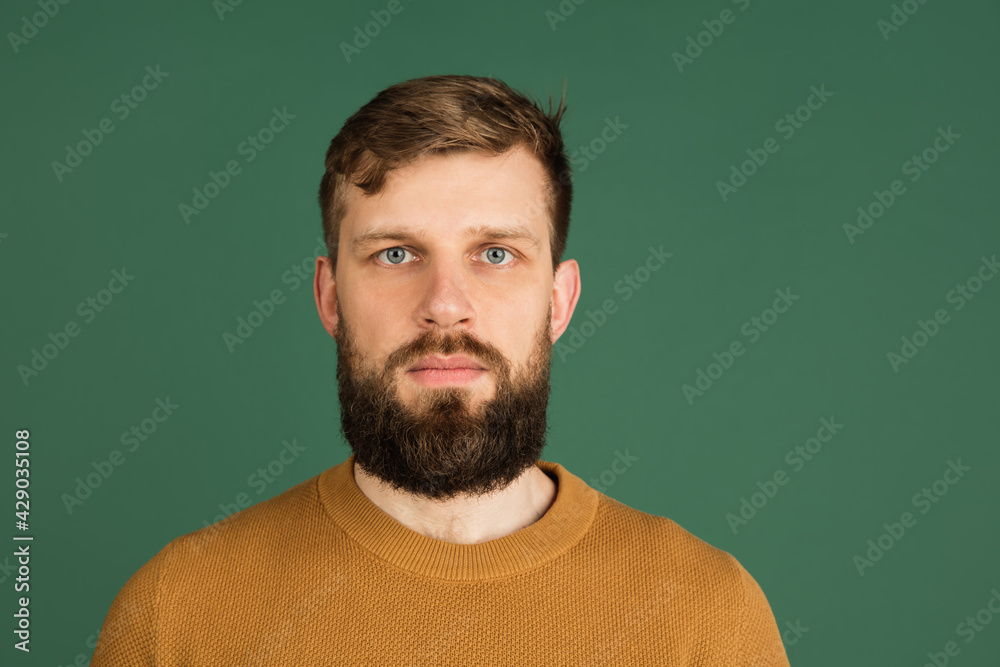 Caucasian man's portrait isolated over green studio background with copyspace Caucasian man's portrait isolated over green studio background with copyspace