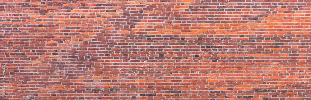 Obraz premium A wall of old, darkened bricks. Wide panoramic horizontal texture.