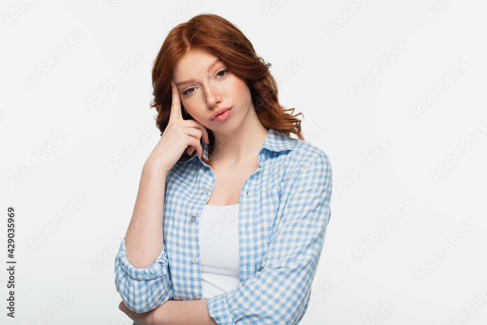 thoughtful redhead woman in blue plaid shirt isolated on white. thoughtful redhead woman in blue plaid shirt isolated on white.