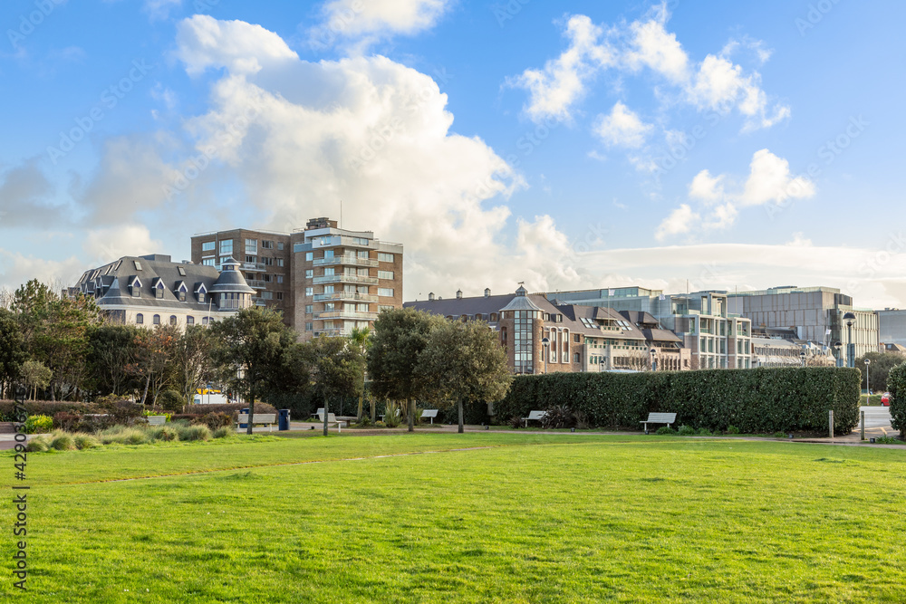 Saint Helier seaside park with office buildings in the foreground, bailiwick of Jersey, Channel Islands