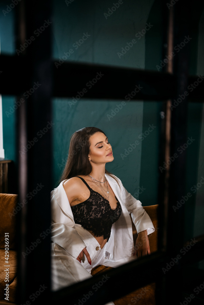 Fashion portrait of pretty sexy young brunette woman in white pantsuit Fashion portrait of pretty sexy young brunette woman in white pantsuit