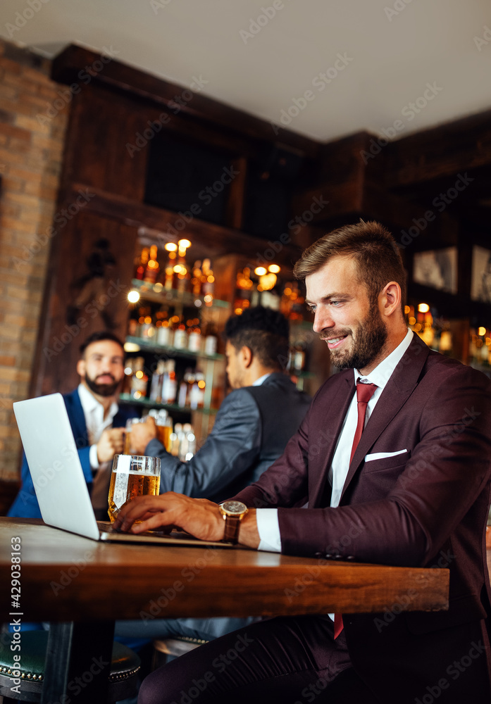 Handsome business man using laptop at his work break in restaurant Handsome business man using laptop at his work break in restaurant