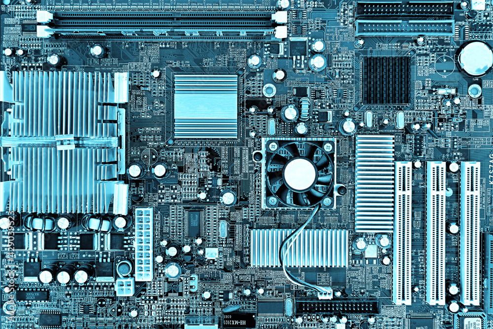 Fototapeta premium Motherboard, printed circuit board in a desktop personal computer. Teal colored, Cyberpunk design.