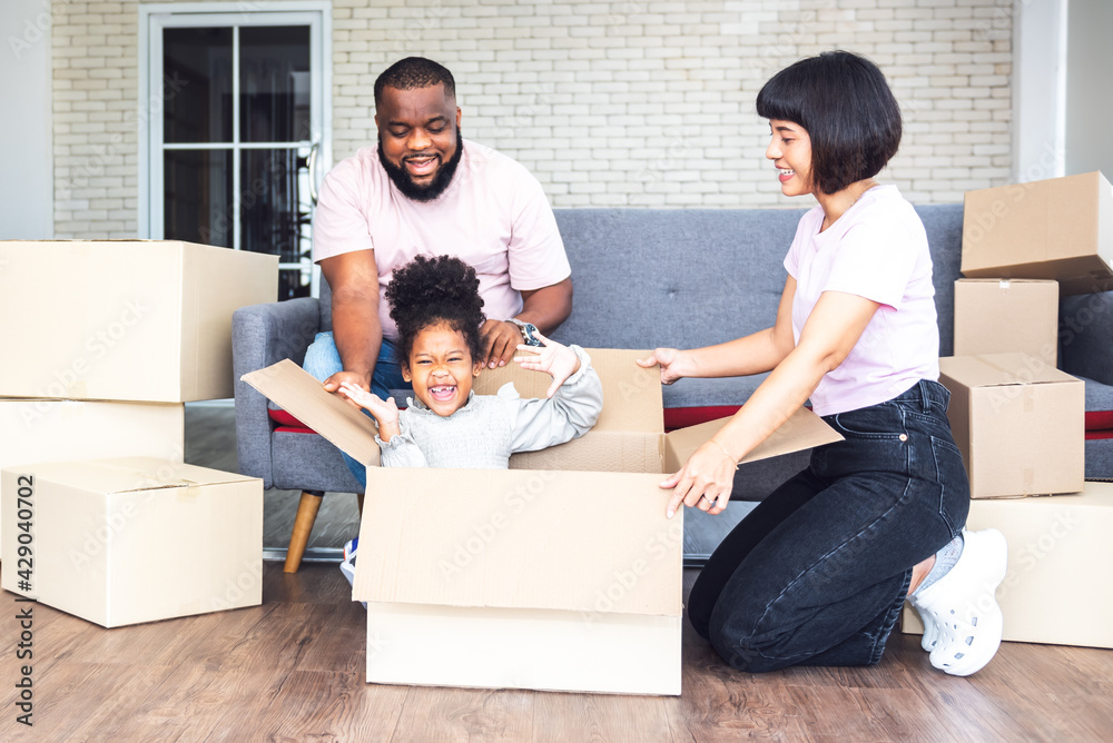 Family, African American father, Asian mother and 5-year-old daughter, they are happy together From moving or relocation to a new home, to family and relationship concept. Family, African American father, Asian mother and 5-year-old daughter, they are happy together From moving or relocation to a new home, to family and relationship concept.