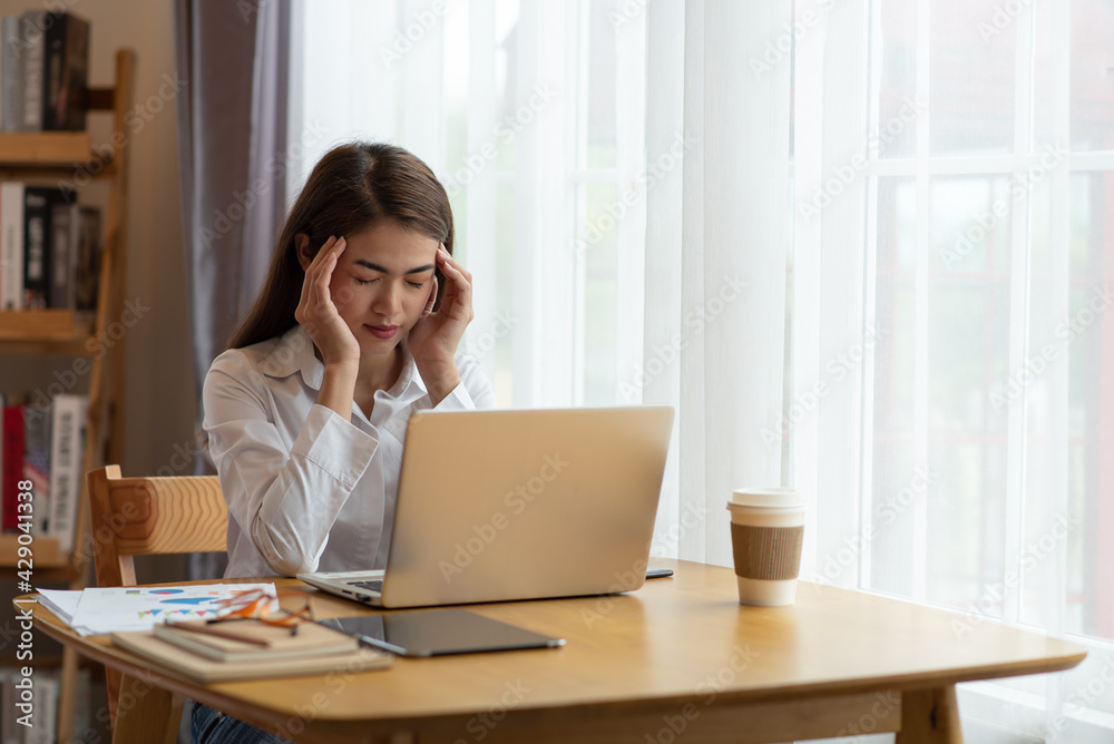 Stressed business woman with palm on face in her office Stressed business woman with palm on face in her office