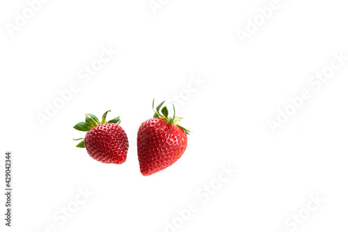 Two berries of juicy ripe strawberries on a white background