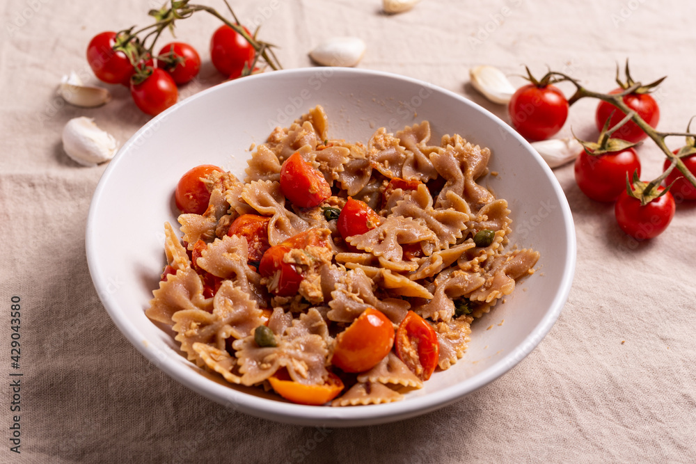 Pasta with tuna, cherry tomatoes and capers. Typical italian dish idea. Pasta with tuna, cherry tomatoes and capers. Typical italian dish idea.