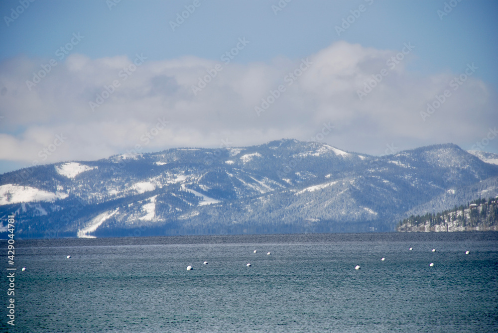 The mountains with snow on the peaks in Lake Tahoe.