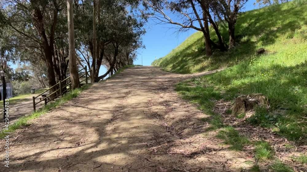 Hiking on a small mountain near the city in a national park. Outdoor sport on a dirt road on a hill. Hiking on a small mountain near the city in a national park. Outdoor sport on a dirt road on a hill.