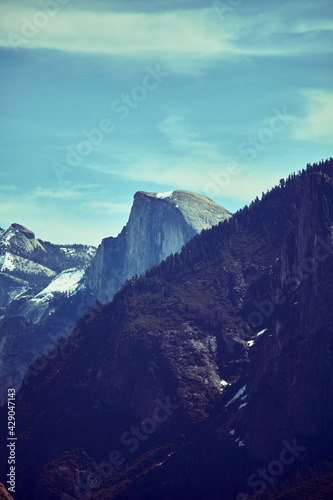 Half Dome Behind Tree Covered Mountain Vertical View
