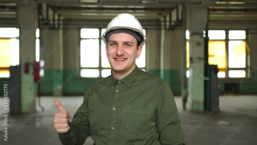 Architect, manager, director enterprise white helmet shows thumbs up, smiles, good mood. Completed project plan, successful business leader, excellent working conditions, recruitment, employment team Architect, manager, director enterprise white helmet shows thumbs up, smiles, good mood. Completed project plan, successful business leader, excellent working conditions, recruitment, employment team