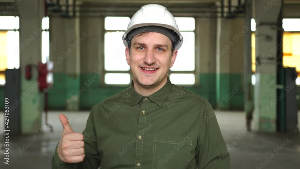 Architect, manager, director enterprise white helmet shows thumbs up, smiles, good mood. Completed project plan, successful business leader, excellent working conditions, recruitment, employment team