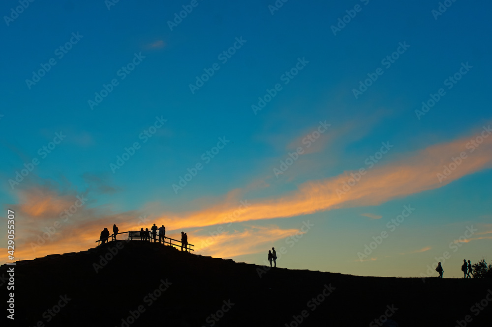 Silhouette of people from the back with the beautiful sunset background Silhouette of people from the back with the beautiful sunset background