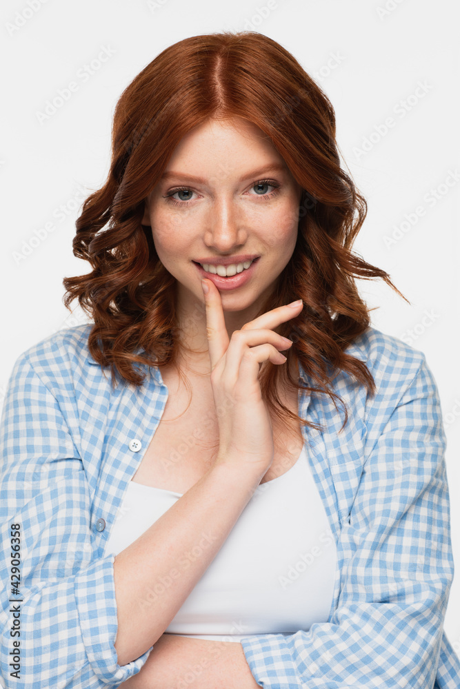 happy redhead young woman in blue checkered shirt looking at camera isolated on white. happy redhead young woman in blue checkered shirt looking at camera isolated on white.