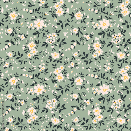 Trendy seamless vector floral pattern. Endless print made of small white flowers. Summer and spring motifs. Green gray background. Stock vector illustration.