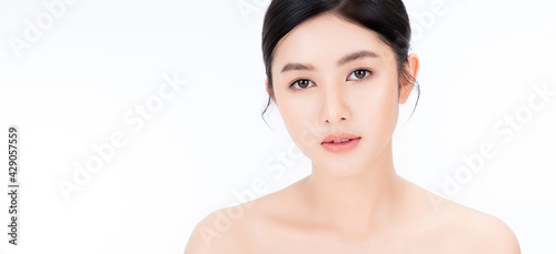 Closeup portrait of beauty asian woman with fair perfect healthy glow skin bare shoulder isolated copy space, young beautiful asia girl with pretty smile on face. Beauty korean clinic skincare banner