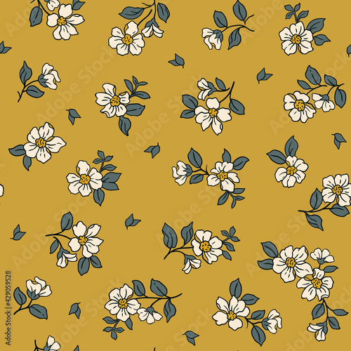 Beautiful vintage floral pattern in small realistic flowers. Small white  flowers. Old gold background. Liberty style print. Floral seamless background. The elegant the template for fashion prints.