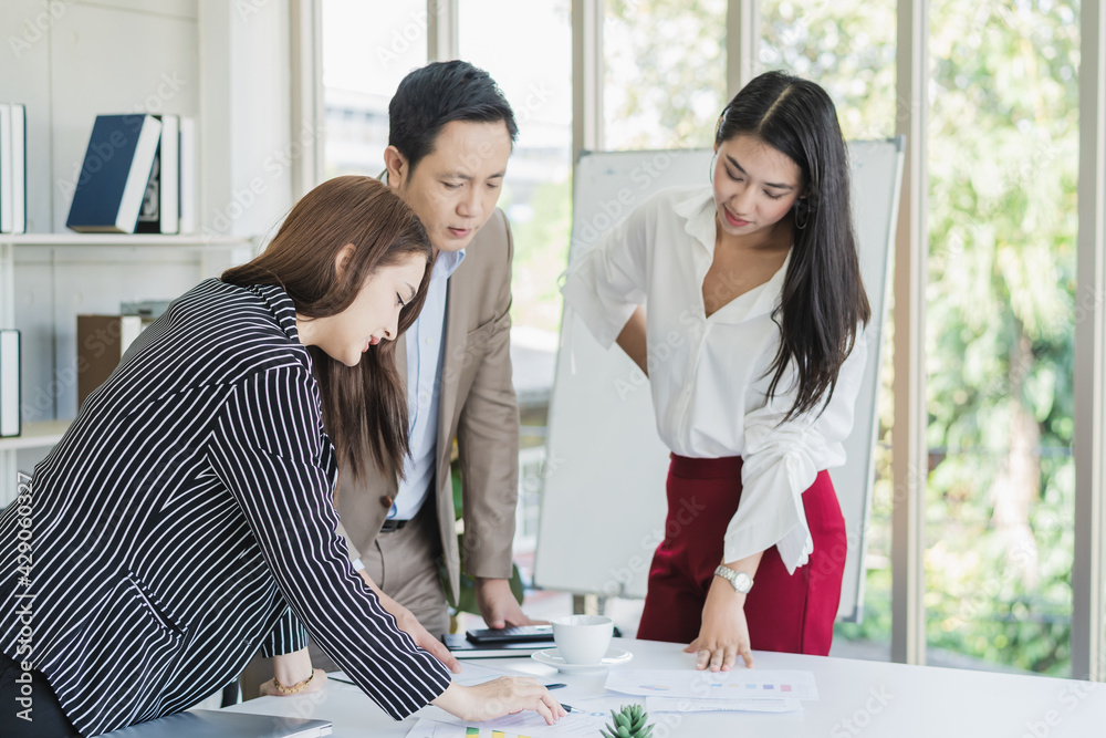 Fototapeta premium Team, Group of asian young businessman, businesswoman people working marketing plan, discussing on paperwork with teamwork, colleagues at office, workplace. Brainstorm, discuss business concept.