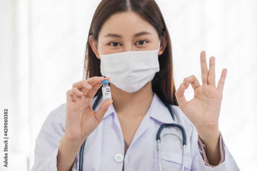 Covid-19, coronavirus hand of asian young woman or female doctor, nurse holding vaccine vial, healthcare and medical. Vaccination, immunization or disease prevention against or virus pandemic concept. Covid-19, coronavirus hand of asian young woman or female doctor, nurse holding vaccine vial, healthcare and medical. Vaccination, immunization or disease prevention against or virus pandemic concept.